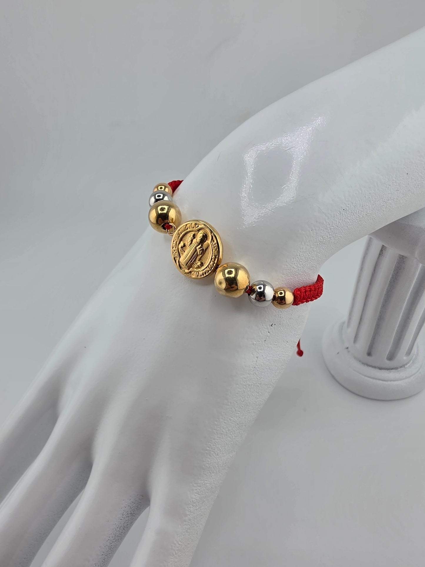 Red Bracelet with 3 gold spheres and Saint Benedict pendant