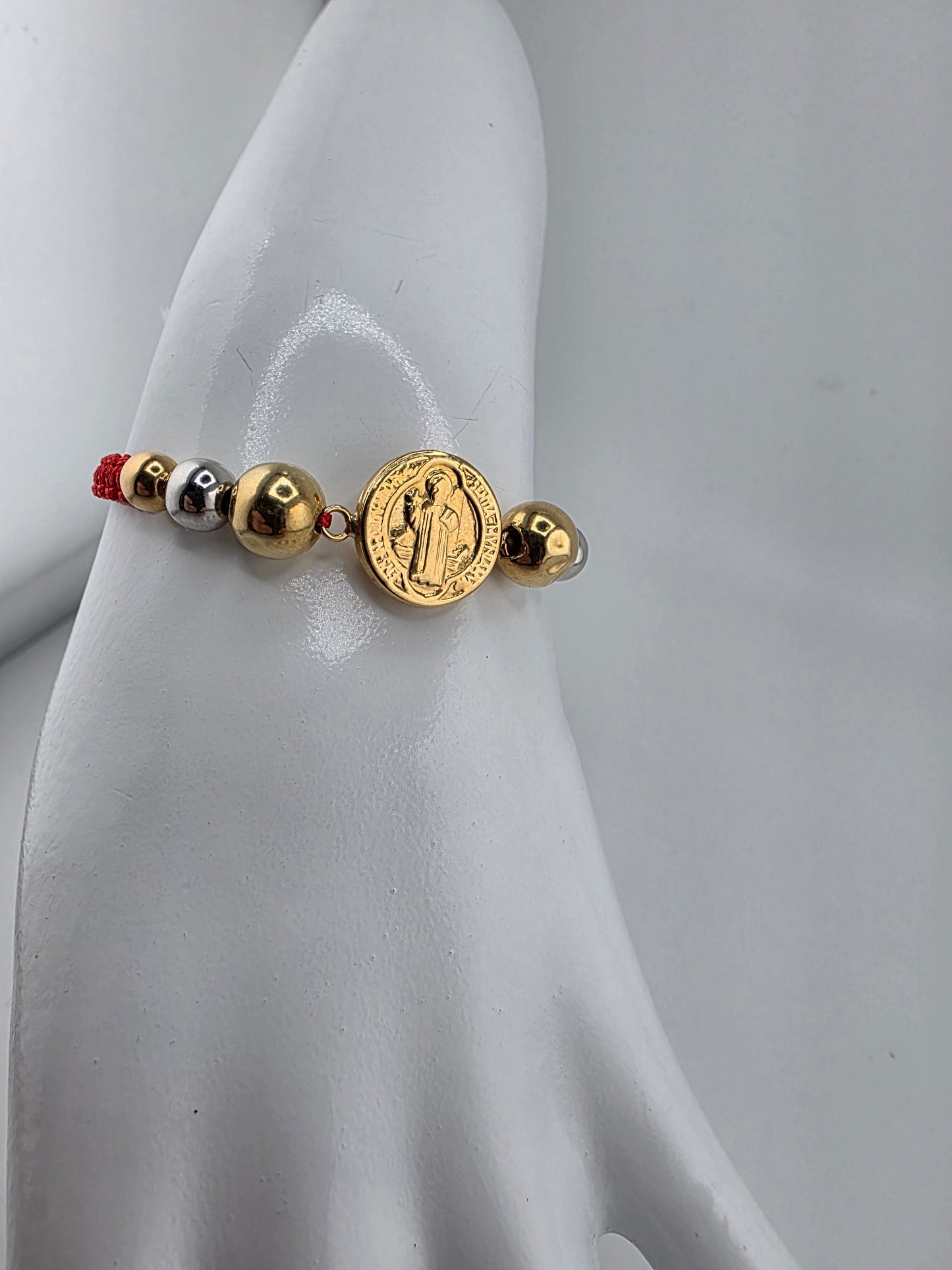 Red Bracelet with 3 gold spheres and Saint Benedict pendant