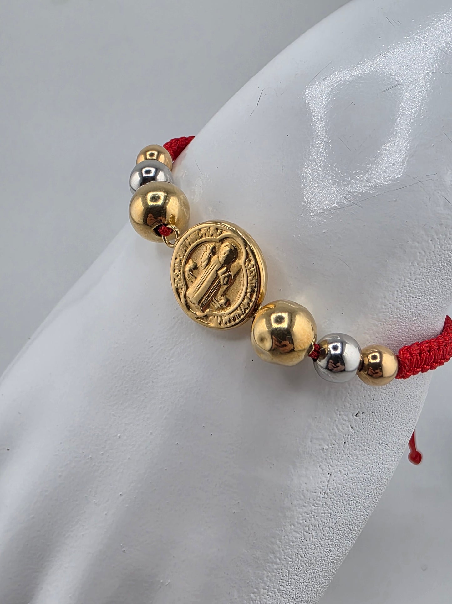 Red Bracelet with 3 gold spheres and Saint Benedict pendant