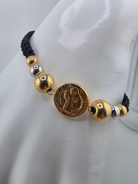 Black bracelet with 3 gold spheres and Saint Benedict charm